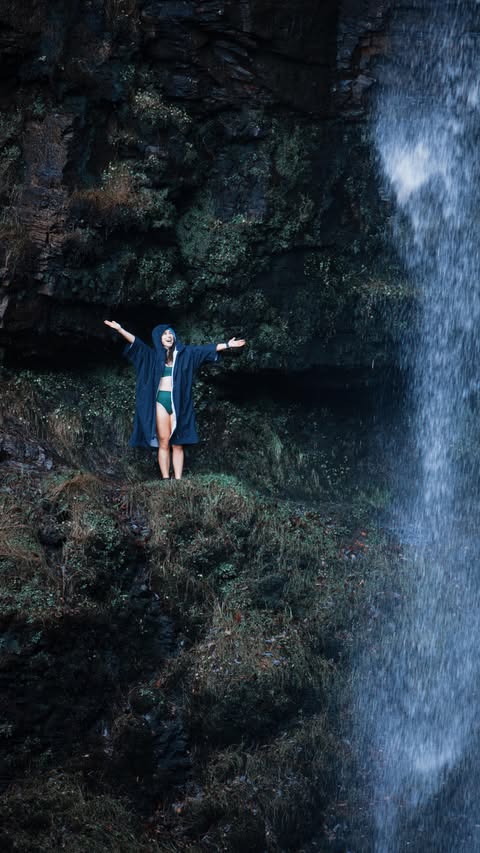 Instagram post by @glutenfreewithcharlie for dryrobe. Caption reads: Okay but have you been to this famous waterfall in....