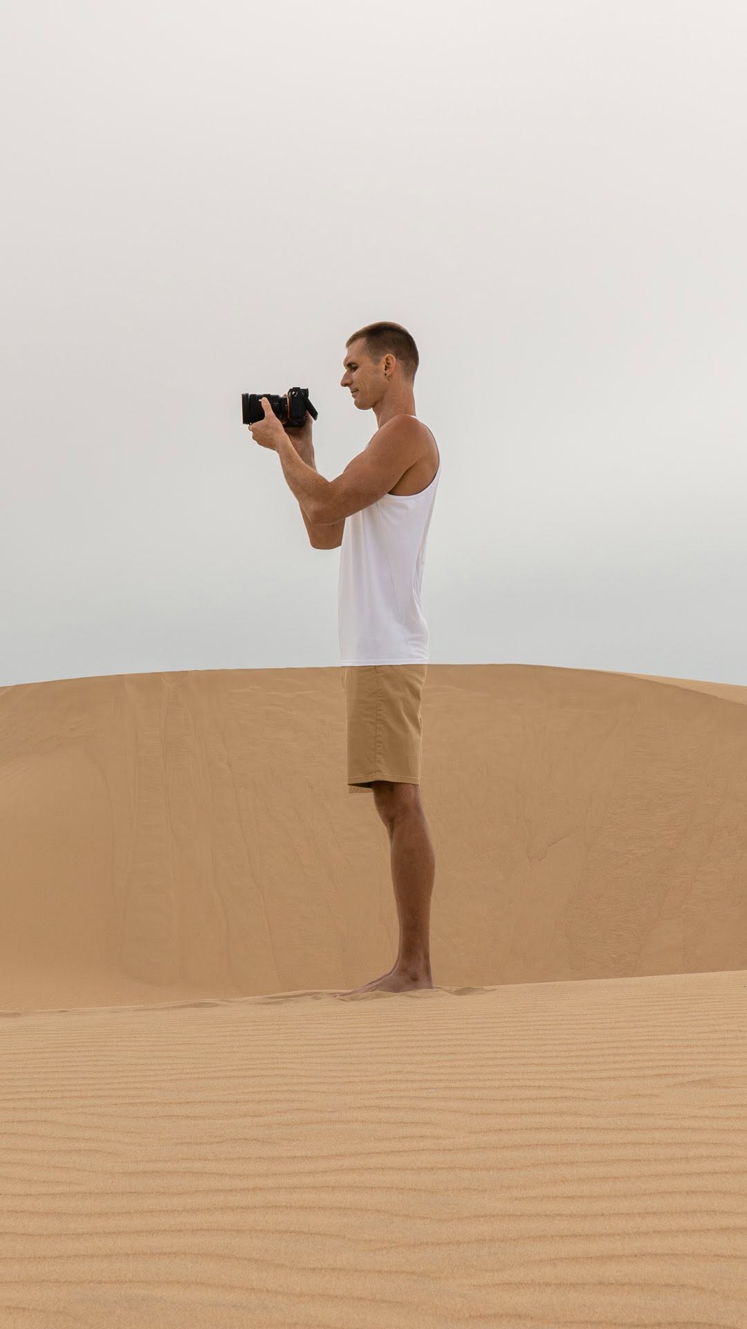 Instagram post by @asenseofhuber for Sony Alpha. Caption reads: 📸 Photo Tricks at the Sand Dunes ⏳☂️....