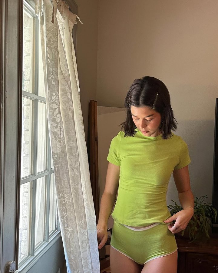 Instagram post by @nataliewoolz for Organic Basics. Caption reads: Brat summer at home🍏 

Wearing @organicbasics....