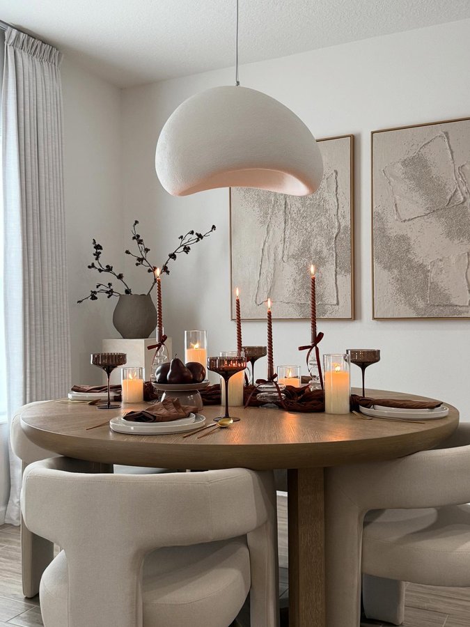 Instagram post by @lauri_b for Rooms To Go. Caption reads: Earthy tones, candlelight & all the cozy vibes....