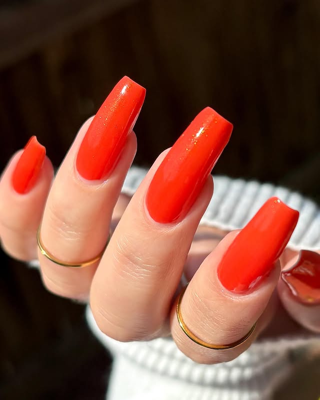 Instagram post by @cozychai.nails for Cracked Polish. Caption reads: It’s Electric - @crackedpolish 🍊🧡⚡️ *paid pr....