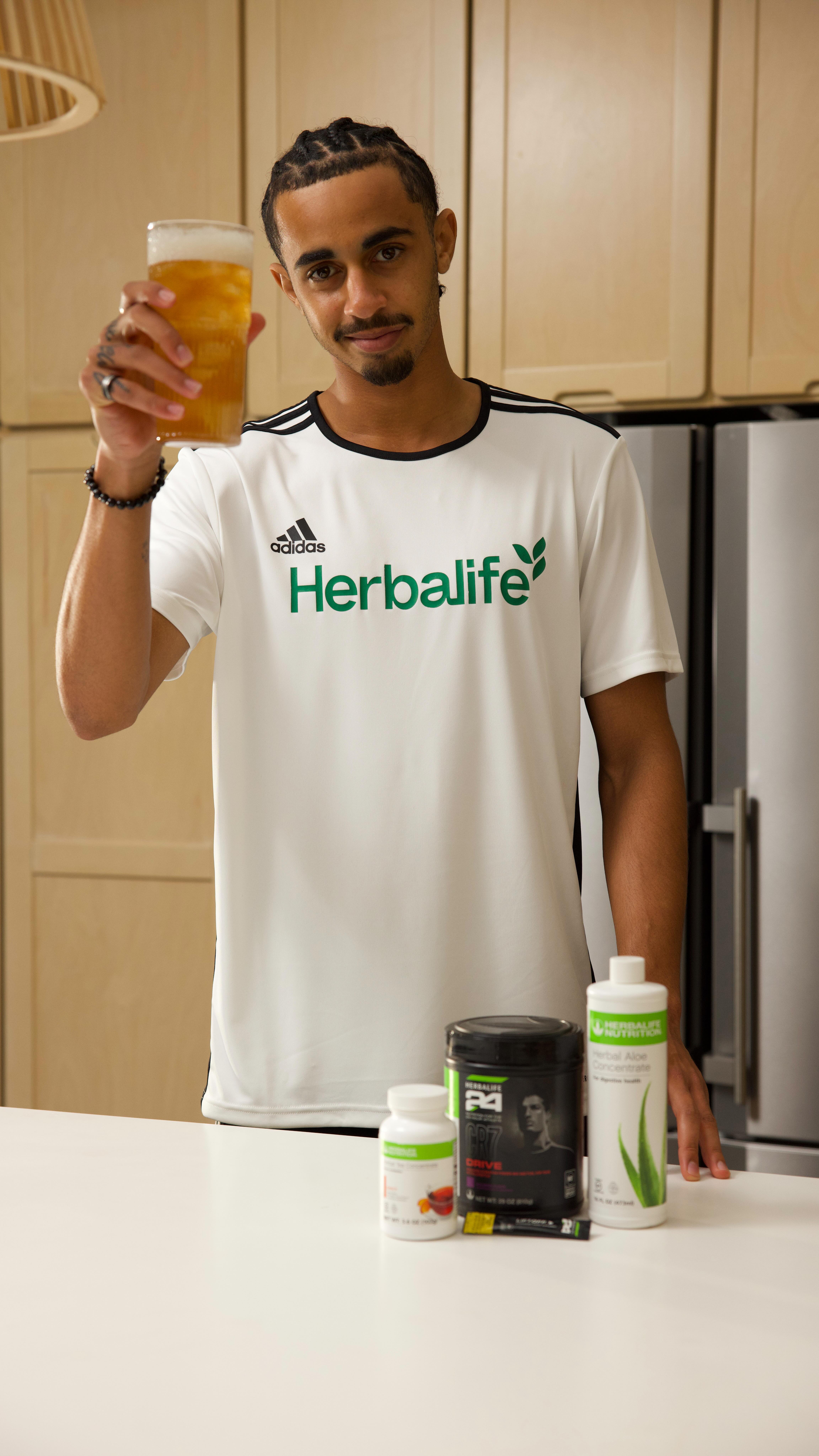 Instagram post by @jalenneal_ for Herbalife. Caption reads: My go-to refresher. 🍑⚡ 
 Liftoff for energy,....