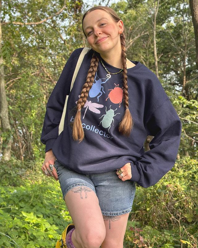 Instagram post by @hannahdrapinski for Bonfire. Caption reads: I MADE MERCH!!! 🪲🦋✨🌀🐌💫🐞 you all loved the....