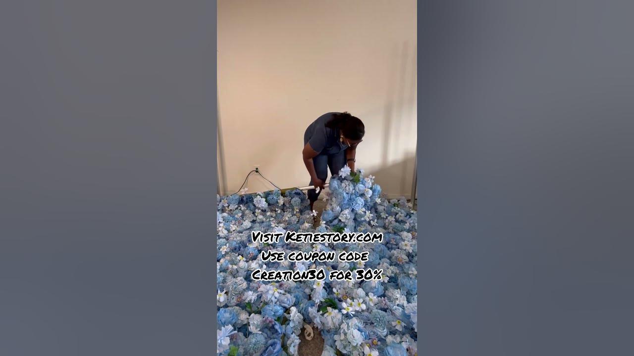 YouTube post by @CustomEventCreations for KetieStory. Caption reads: Flower Wall Unboxing #flowerwall #backdrop.