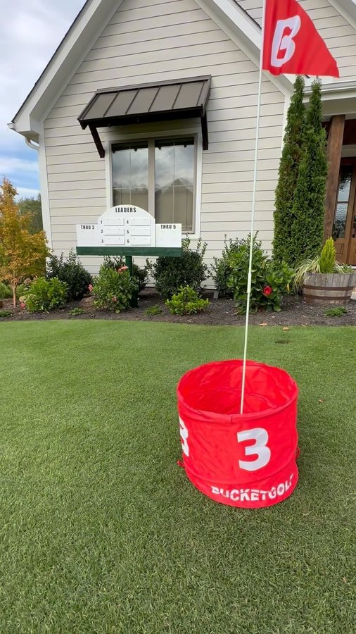 Instagram post by @the.lawn.dad for Bucketgolf Game. Caption reads: Be honest, how big of a divot are you taking on my....