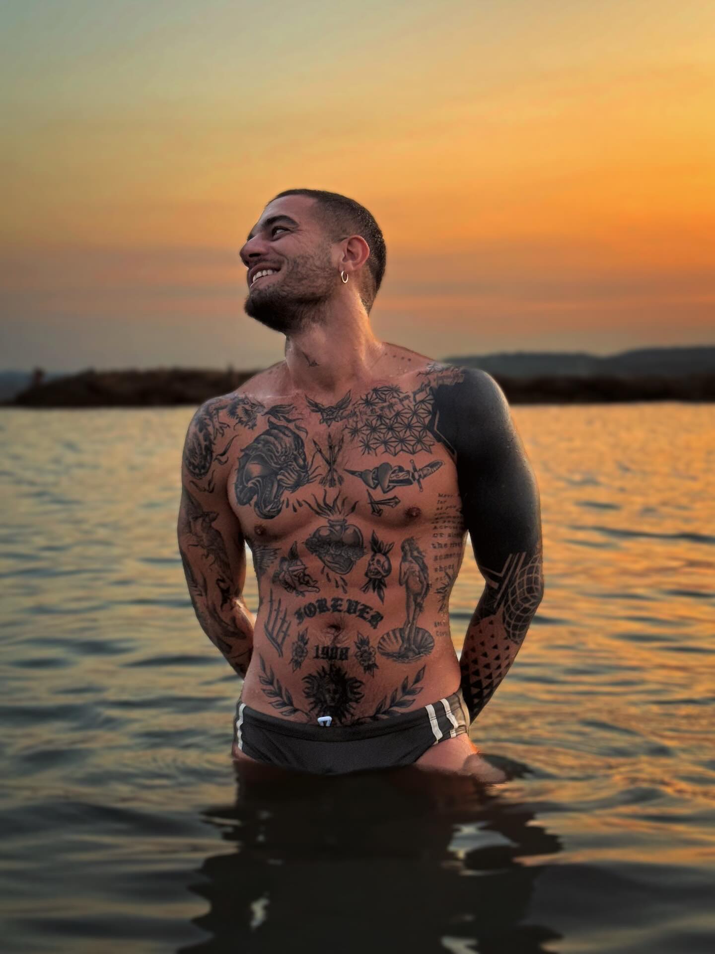 Instagram post by @alexink_official for Coyote Jocks. Caption reads: 🌅

🩲 @coyotejocks @coyoteswims 

#goldenhour....
