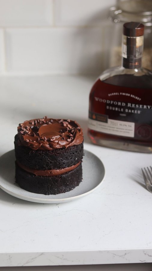Instagram post by @bakedbybenji for Woodford Reserve. Caption reads: Make this mini chocolate cake with me, the perfect....