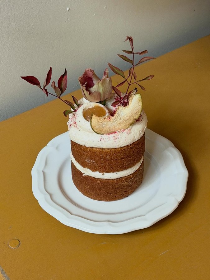 Instagram post by @fromlucienyc for Free People. Caption reads: Vanilla cake with apple compote and maple brown....