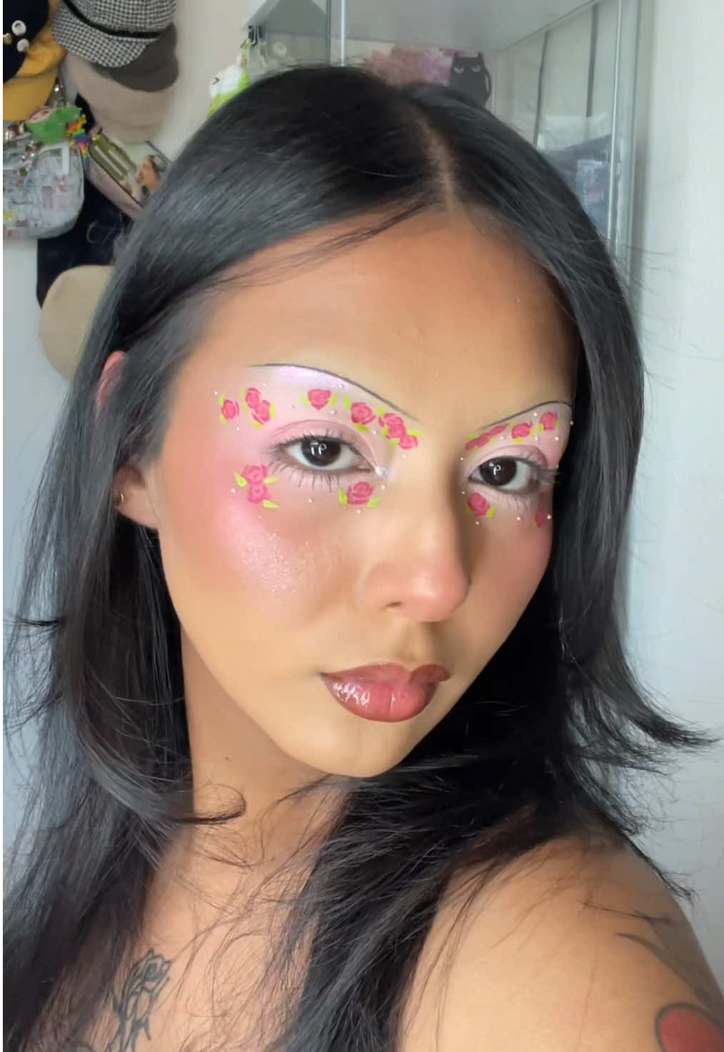 TikTok post by @uselessalien for About-face Beauty. Caption reads: Betsey Johnson inspired flower print makeup 🌹🩷 I....