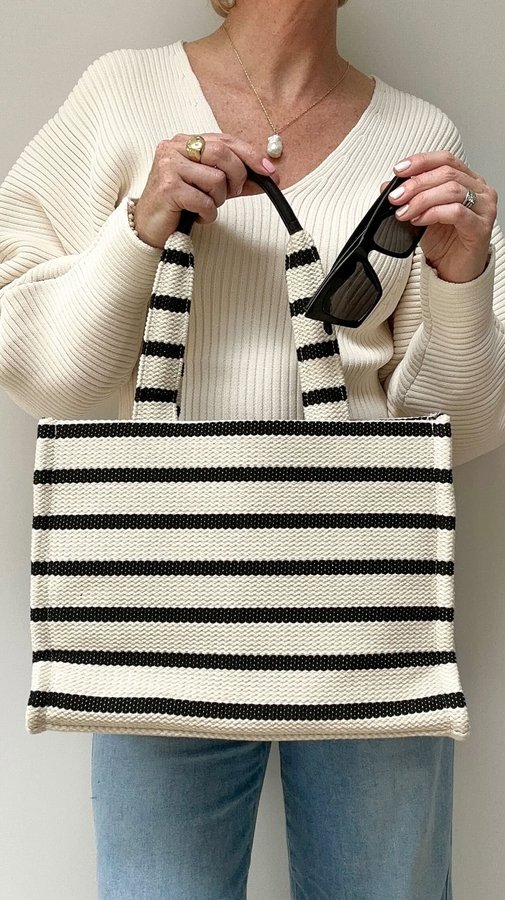 Instagram post by @stripeycoral for Russell & Bromley. Caption reads: My casual weekend look for last minute holiday....