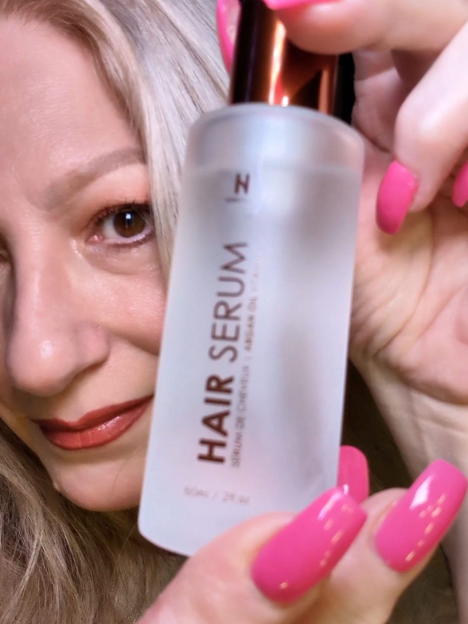 TikTok post by @itsme.ker for HerStyler Haircare. Caption reads: Herstyler Argan Oil Hair Serum, Anti-Frizz Hair....