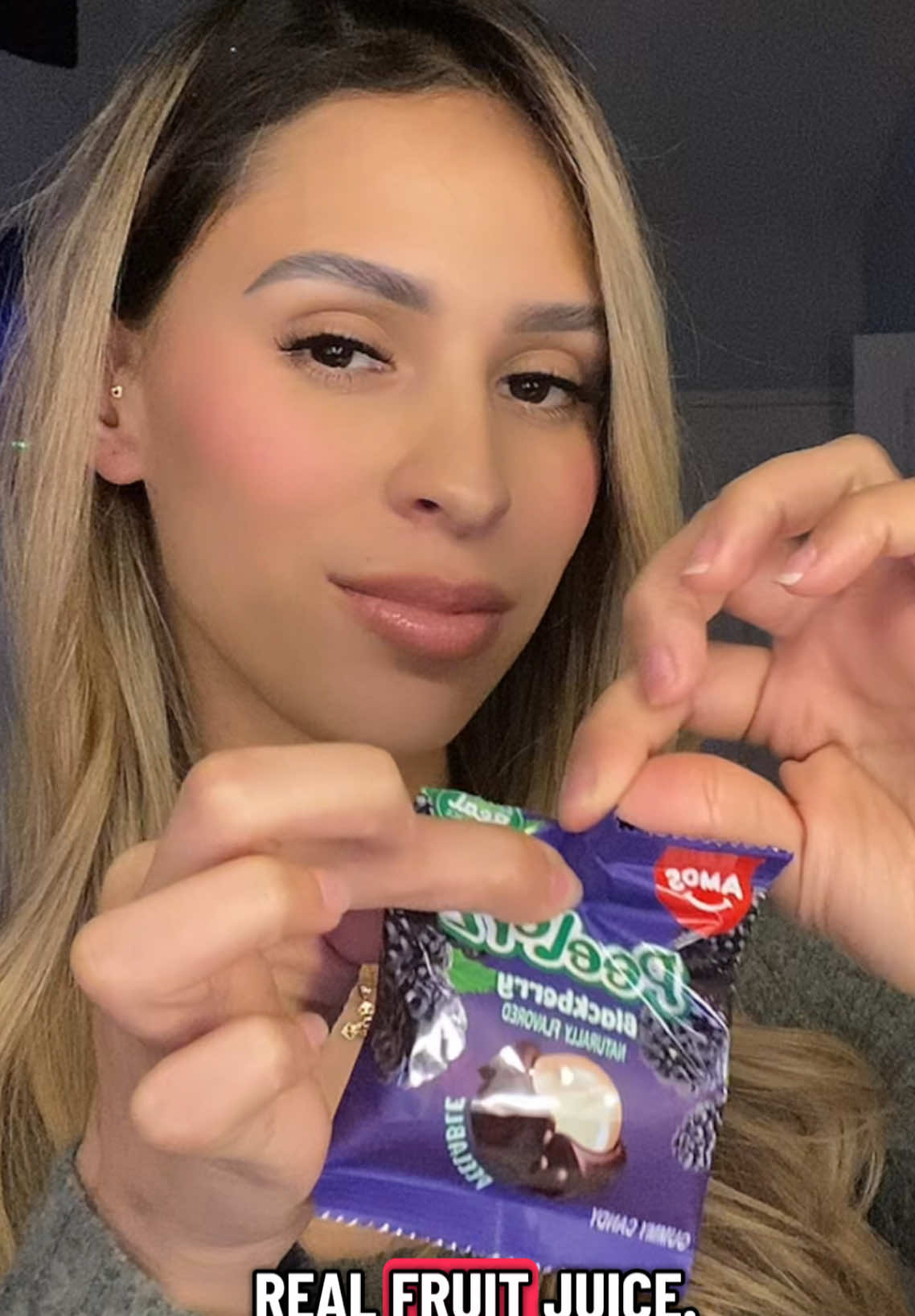 TikTok post by @kayycm for Amos Sweets. Caption reads: [...] ❤️😂 I’m obsessed!! 😚 @Amos Sweets #amos....