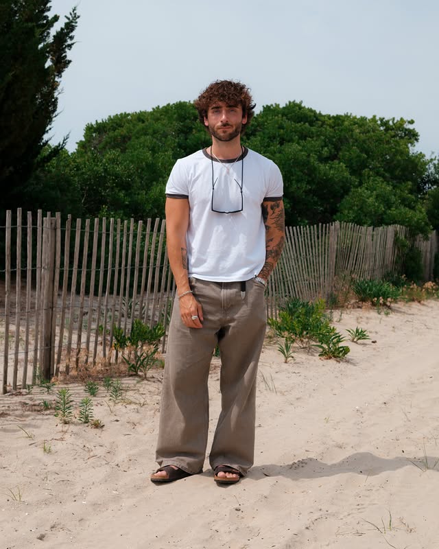 Instagram post by @theyoungwretch for Birkenstock. Caption reads: [...] more sun filled and sandy feet days....