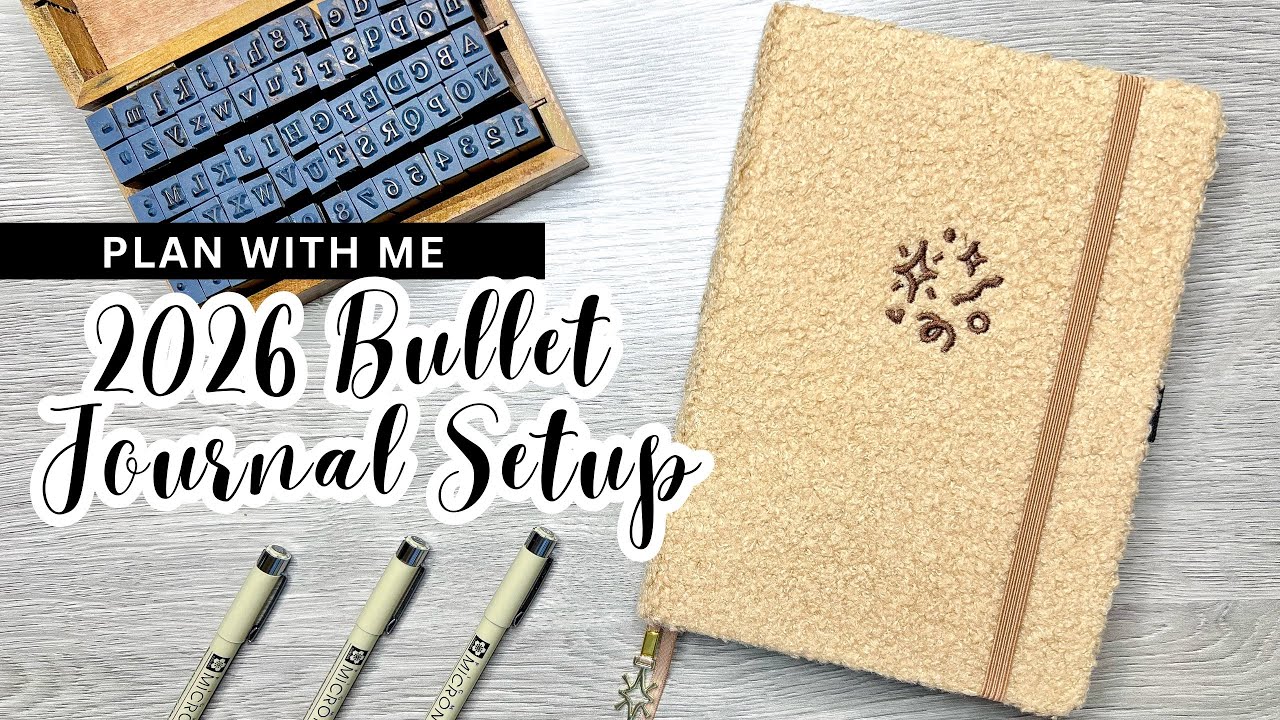 YouTube post by @CreativeMindsCoffeeGrinds for Phomemo. Caption reads: PLAN WITH ME || 2026 Bullet Journal Setup.