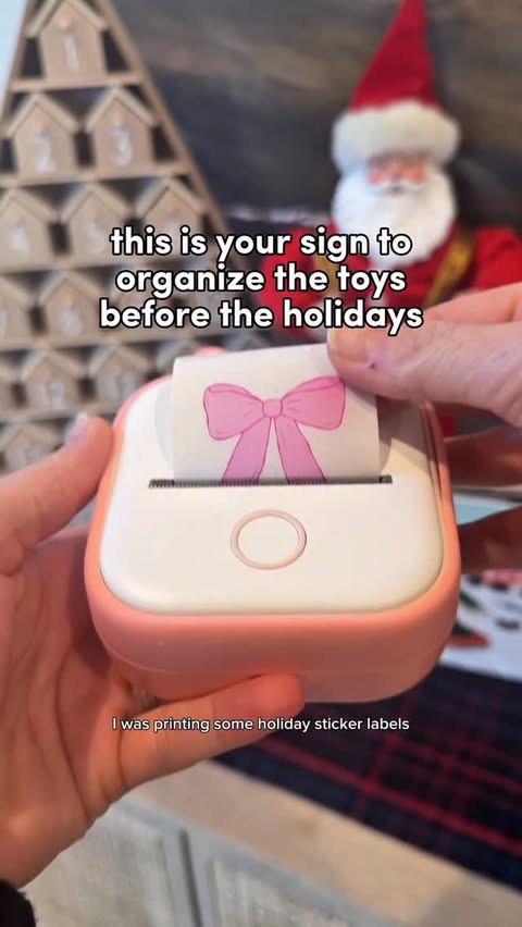 Instagram post by @twinsandatoddlertravel for Phomemo. Caption reads: #ad🎄 the perfect “toy” for everyone in the....