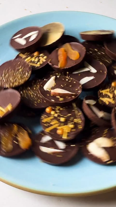 Instagram post by @francescadzani for Delish. Caption reads: Using a muffin tin to make Homemade Hanukkah Gelt....