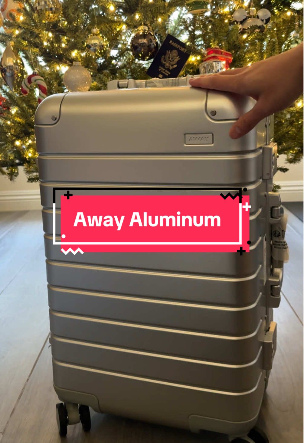 TikTok post by @kevin.vinyl for Away. Caption reads: [...] arrive in time for Christmas! @Away Travel....