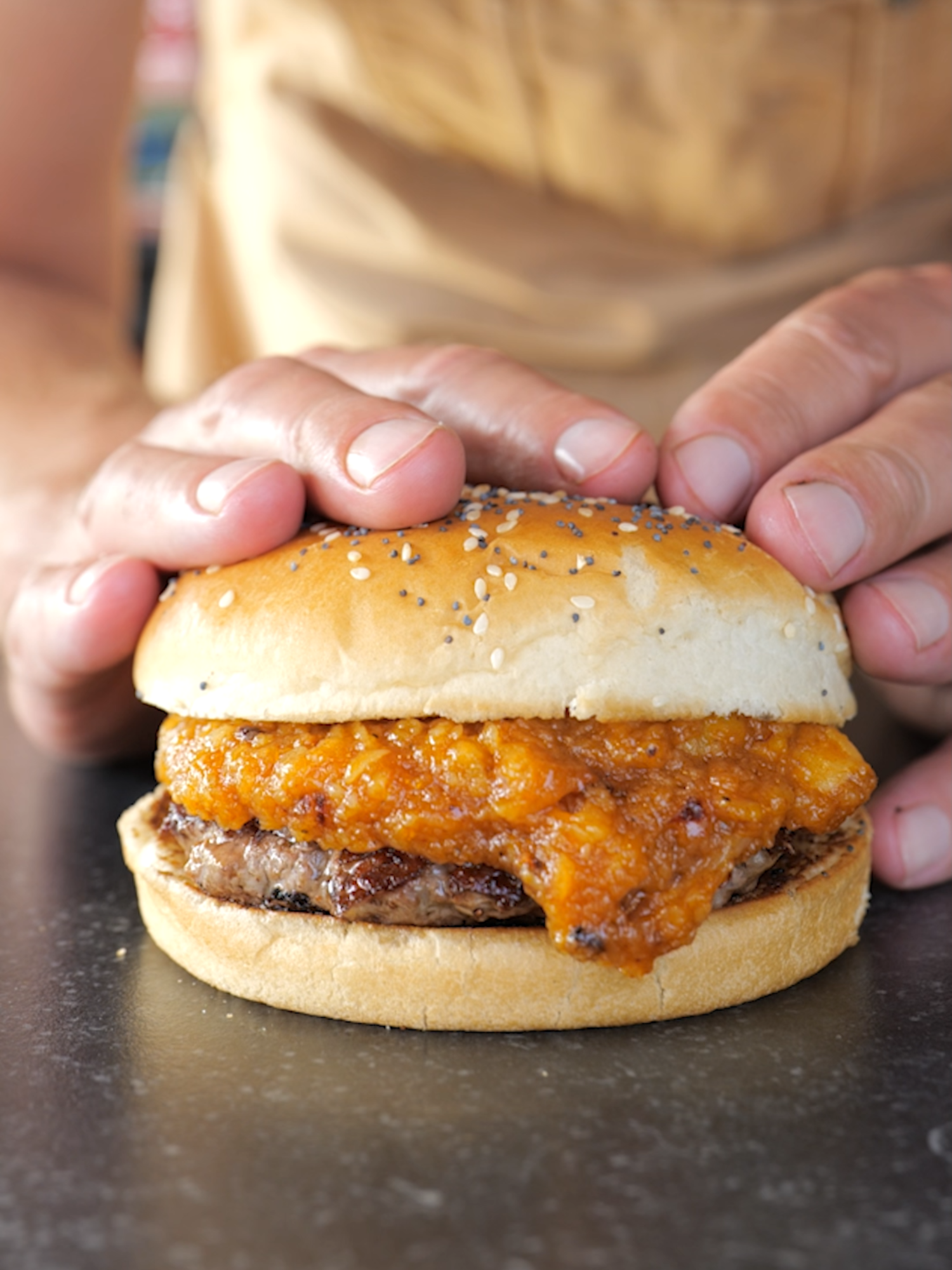 TikTok post by @pitmasterx for Kamado Joe. Caption reads: I Tried Garlic Jam on a Burger and… WOW! 🔥....