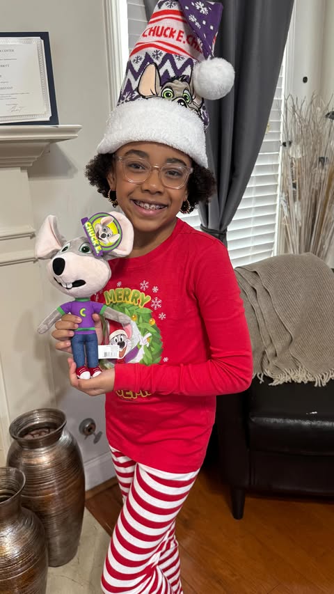 Instagram post by @zigazoo.app for Chuck E. Cheese. Caption reads: 🎁✨ Holiday surprise! Paige just unboxed her....