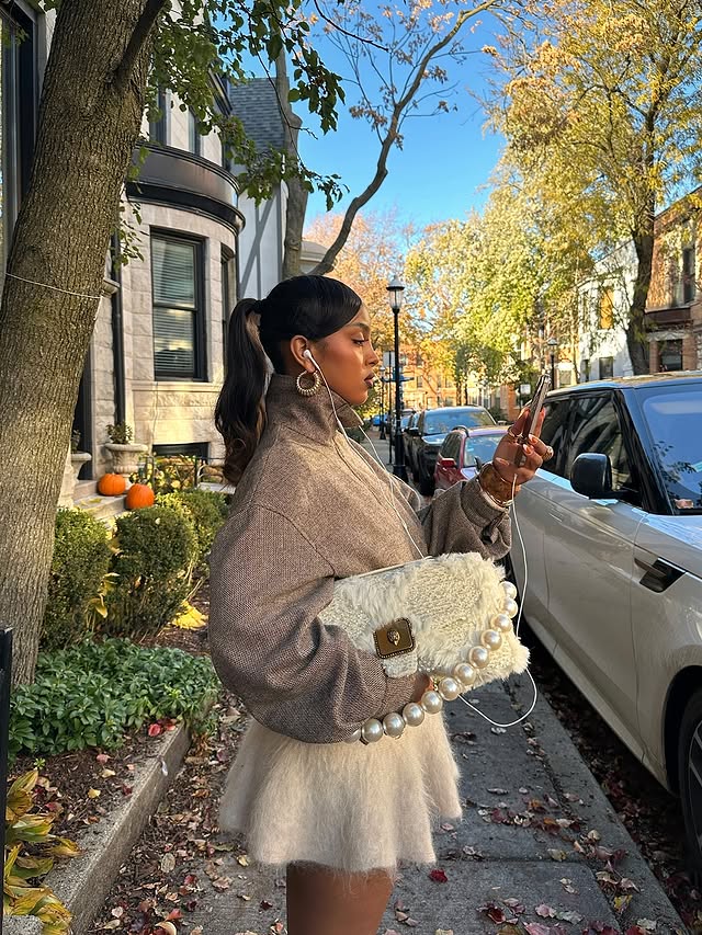 Instagram post by @im_blacklily for Kurt Geiger. Caption reads: Wearing my new furry @kurtgeiger Pimlico bag 🤎....