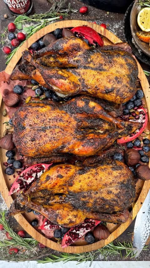 Instagram post by @livefirerepublic for Kingsford. Caption reads: Christmas rotisserie duck with cranberry bourbon....