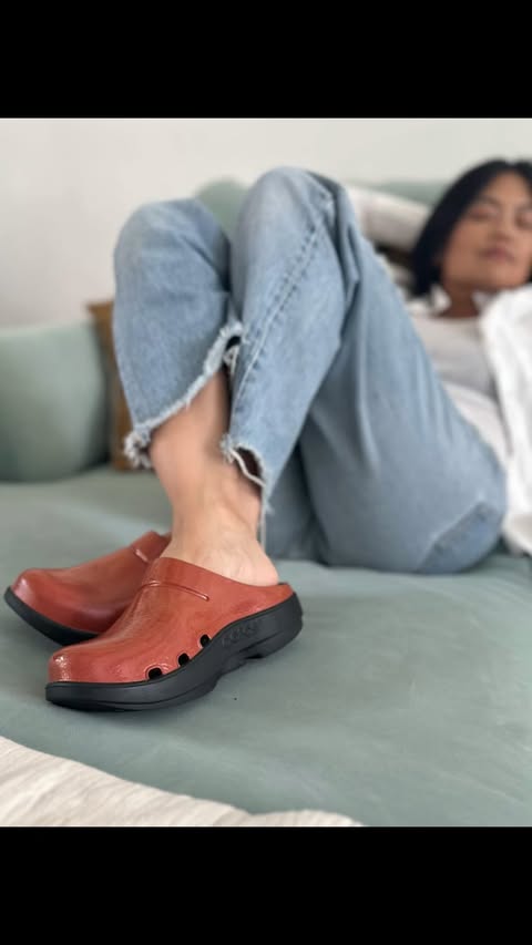 Instagram post by @karenschuang for OOFOS. Caption reads: [...] means I’m always on the go. My OOFOS clogs....