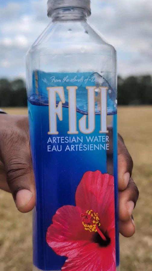 Instagram post by @david11olaoye for FIJI Water. Caption reads: Stay hydrated with Fiji 🌺💦 @fijiwateruk....