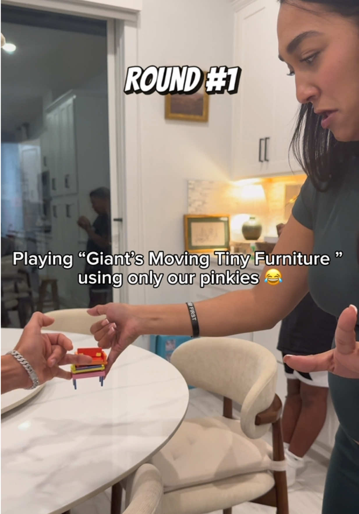 TikTok post by @ashley_annel for Exploding Kittens. Caption reads: Family game night playing “Giants Moving Tiny....