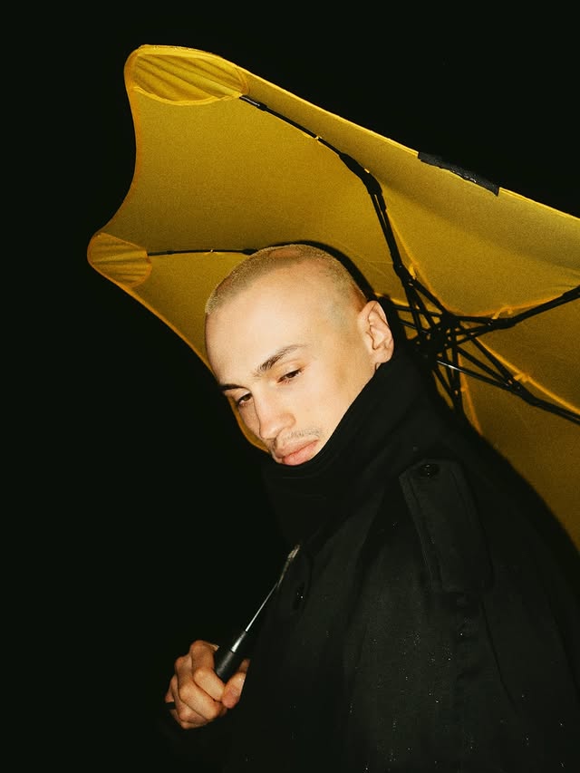 Instagram post by @adam.rhazali for BLUNT Umbrellas. Caption reads: @bluntumbrellas ad.