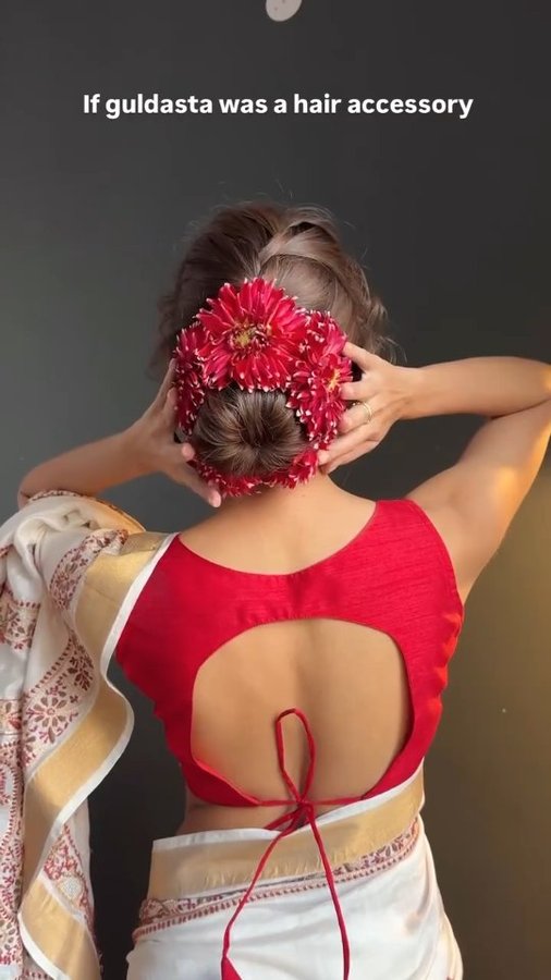 Instagram post by @the_magic_touch_27 for WeddingPlz.com. Caption reads: Beautiful flowers bun hairstyle tutorial// party....