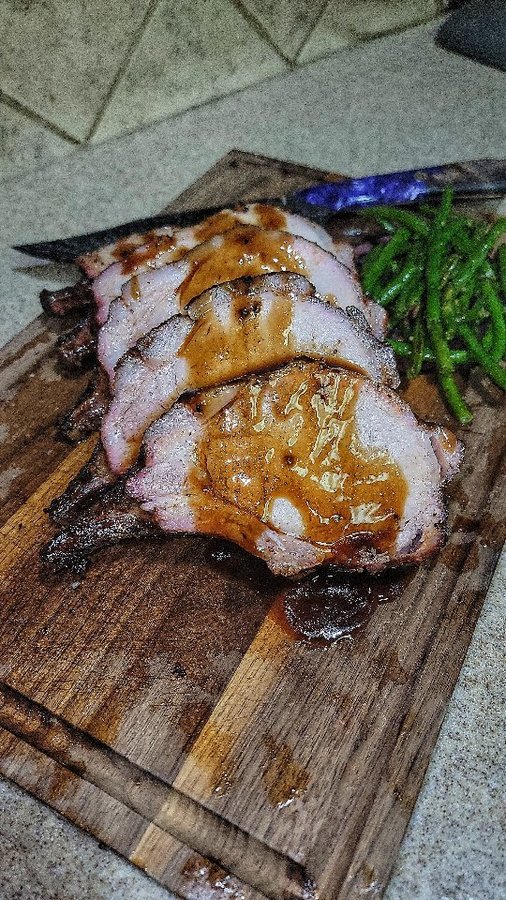Instagram post by @girldadbbq for Spaceman Knives. Caption reads: Smoked Pork Rack with Truffle Demi Glace - The....