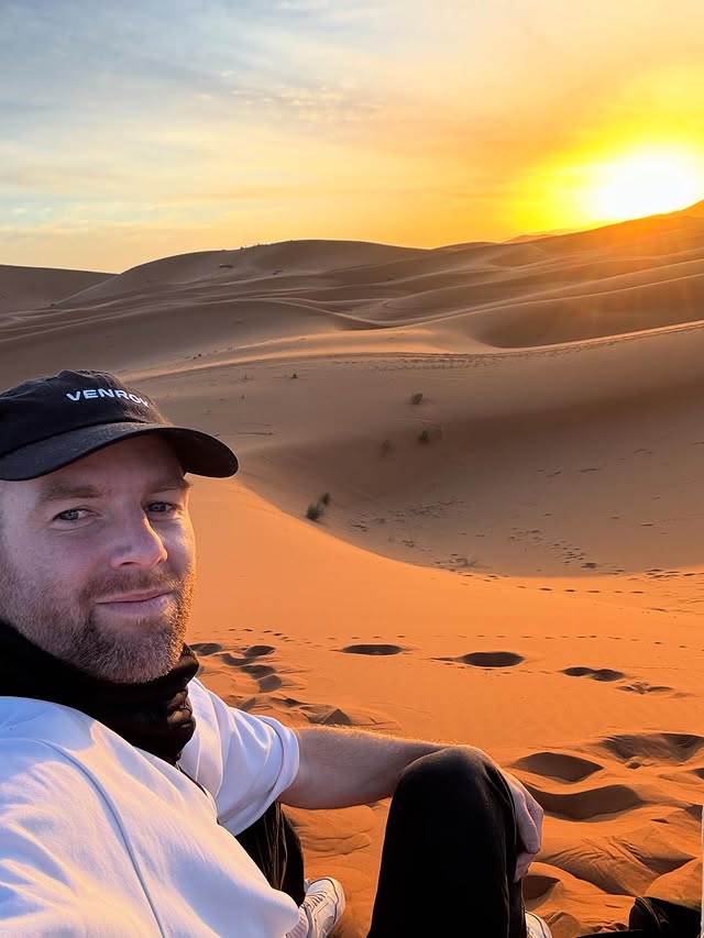 Instagram post by @dochertysam for Intrepid Travel. Caption reads: [...] to camp in the Sahara with @intrepidtravel.