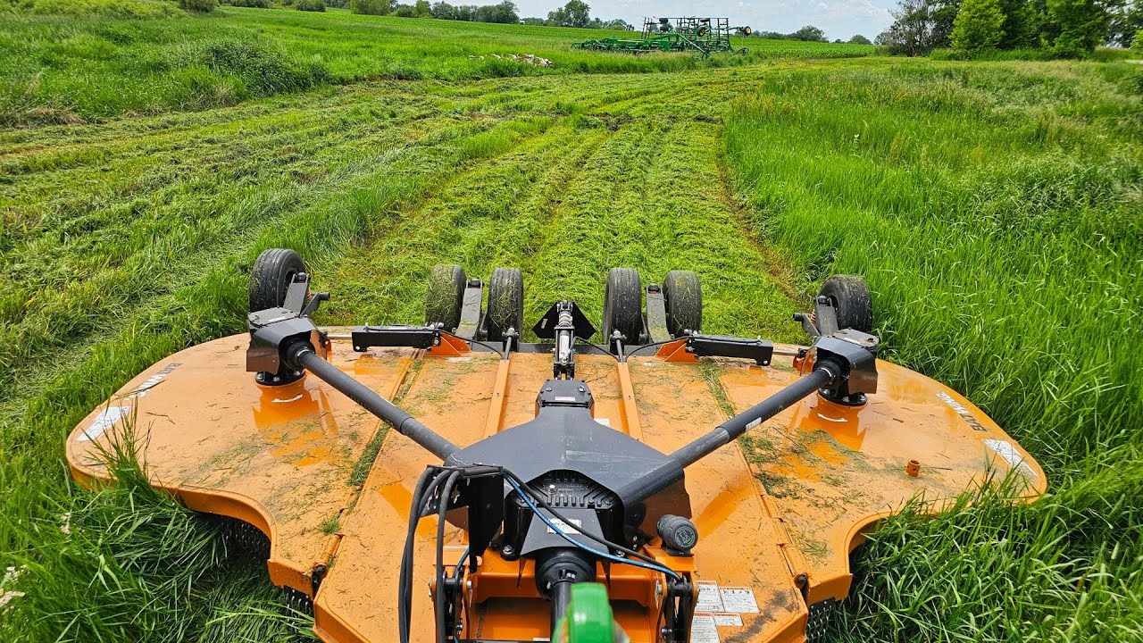 YouTube post by @MillennialFarmer for Drink LMNT. Caption reads: Time to Break Out The Batwing Mower.