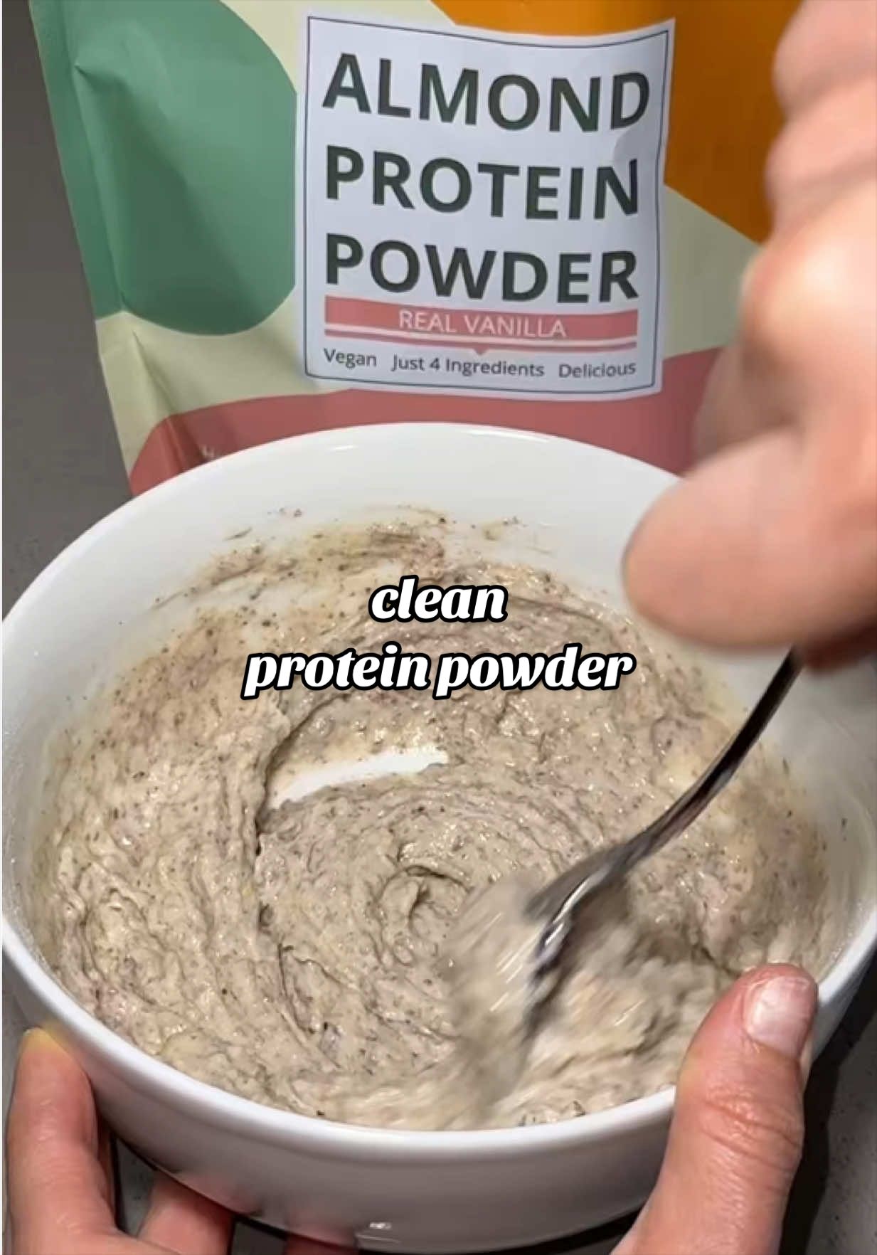 TikTok post by @ugcenchantress for Wellious. Caption reads: love adding @Wellious almond protein powder to my....