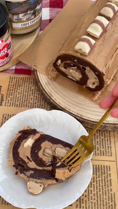 Instagram post by @sophsgoodies for Black Milk. Caption reads: Kinder Bueno Brownie Yule Log ✨🍪🌰🎄An absolute....