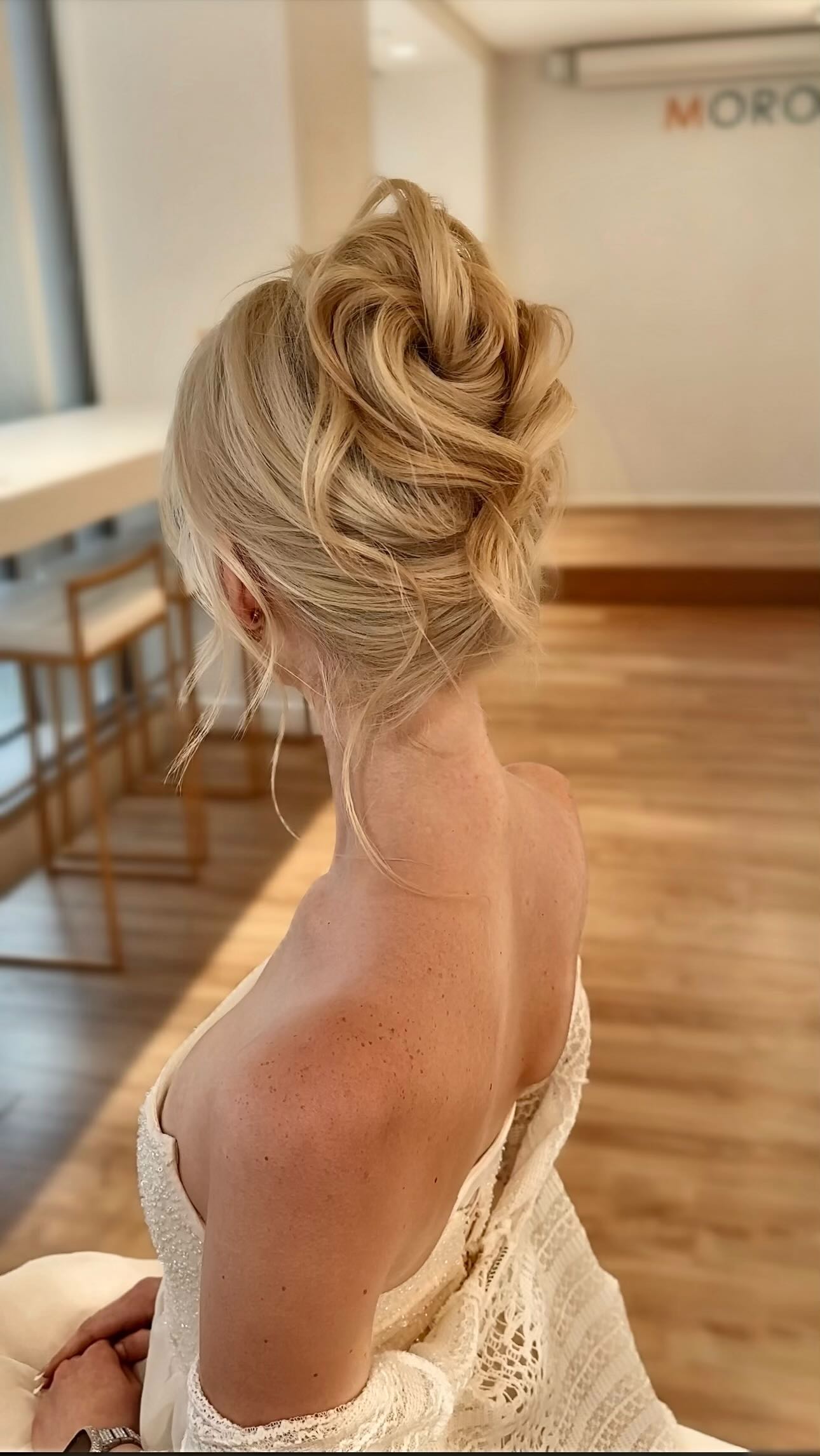 Instagram post by @kasia_fortuna for Moroccanoil Professionals. Caption reads: ✨ Two versions of the vertical bun ✨
Which one....