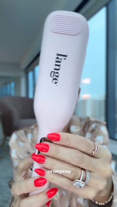 Instagram post by @aivanelli for L'ange Hair. Caption reads: Hotel mirrors, good lighting, and my L’ange = main....