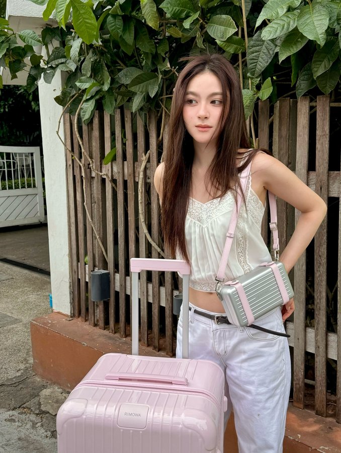 Instagram post by @primiily for RIMOWA. Caption reads: Blush in motion 💗 @rimowa
#RIMOWA....