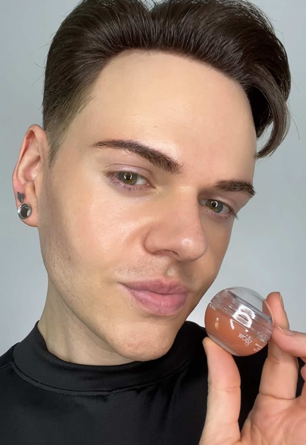 TikTok post by @joshwastjames for Glow Is Here. Caption reads: The glow Peach Peptide Repair Lip Balm is a viral....