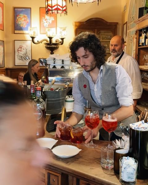 Instagram post by @food_feels for MARTINI. Caption reads: Seeing Italy through the eyes of @martini and....