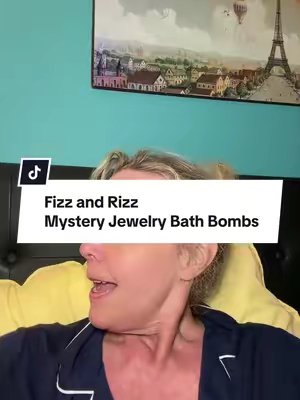 TikTok post by @kimbers_box_of_sunshine for Fizzandrizz. Caption reads: [...] my mystery jewelry bath bombs. @FizzandRizz....