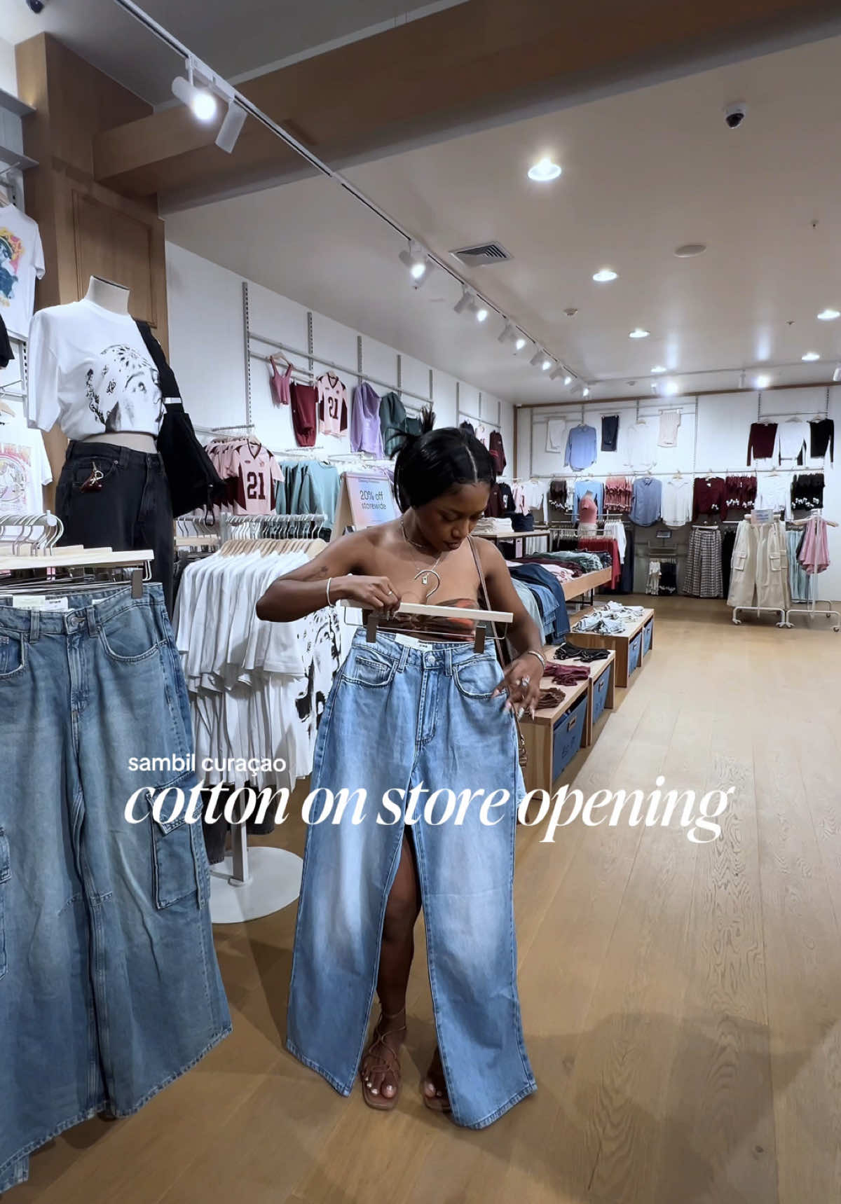 TikTok post by @ghislaine.doran for Cotton On. Caption reads: new store in sambil curaçao🛒🇨🇼 AD @COTTON ON....