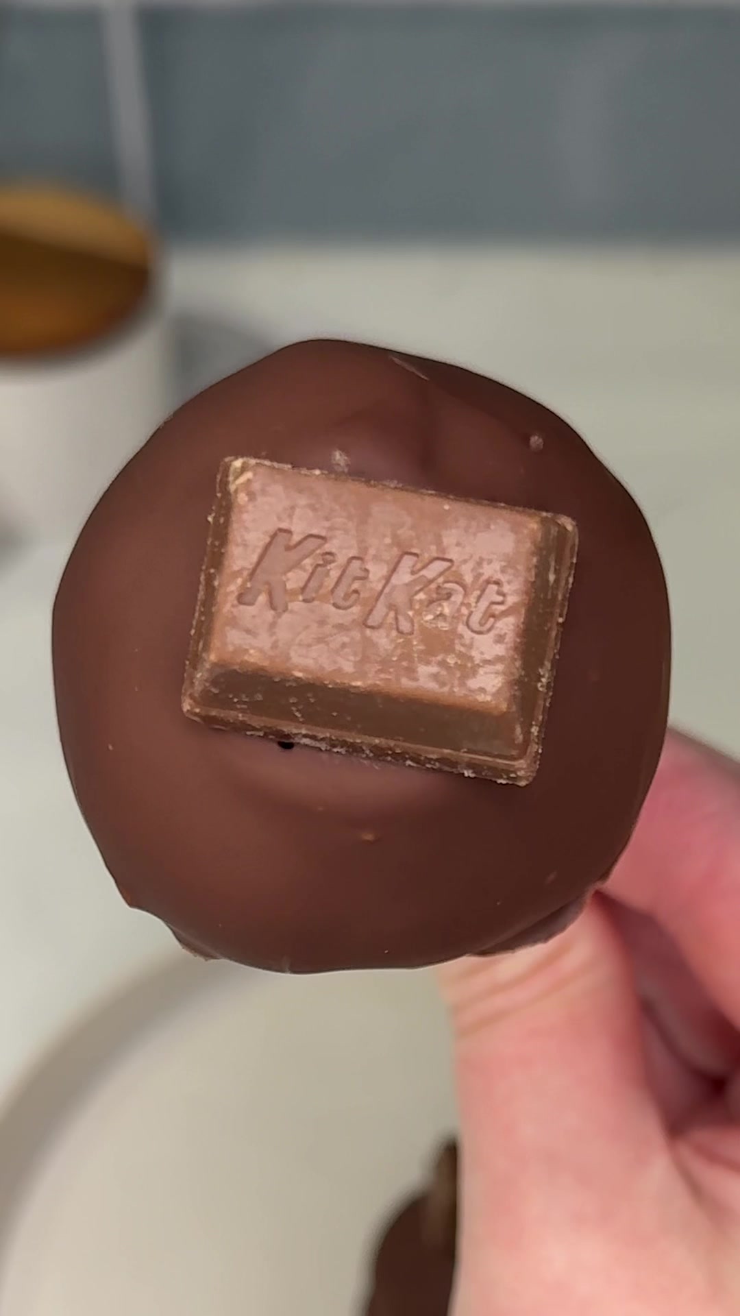 TikTok post by @ashleymarkletreats for KitKat. Caption reads: the easiest kitkat sugar cookie cake pops you will....