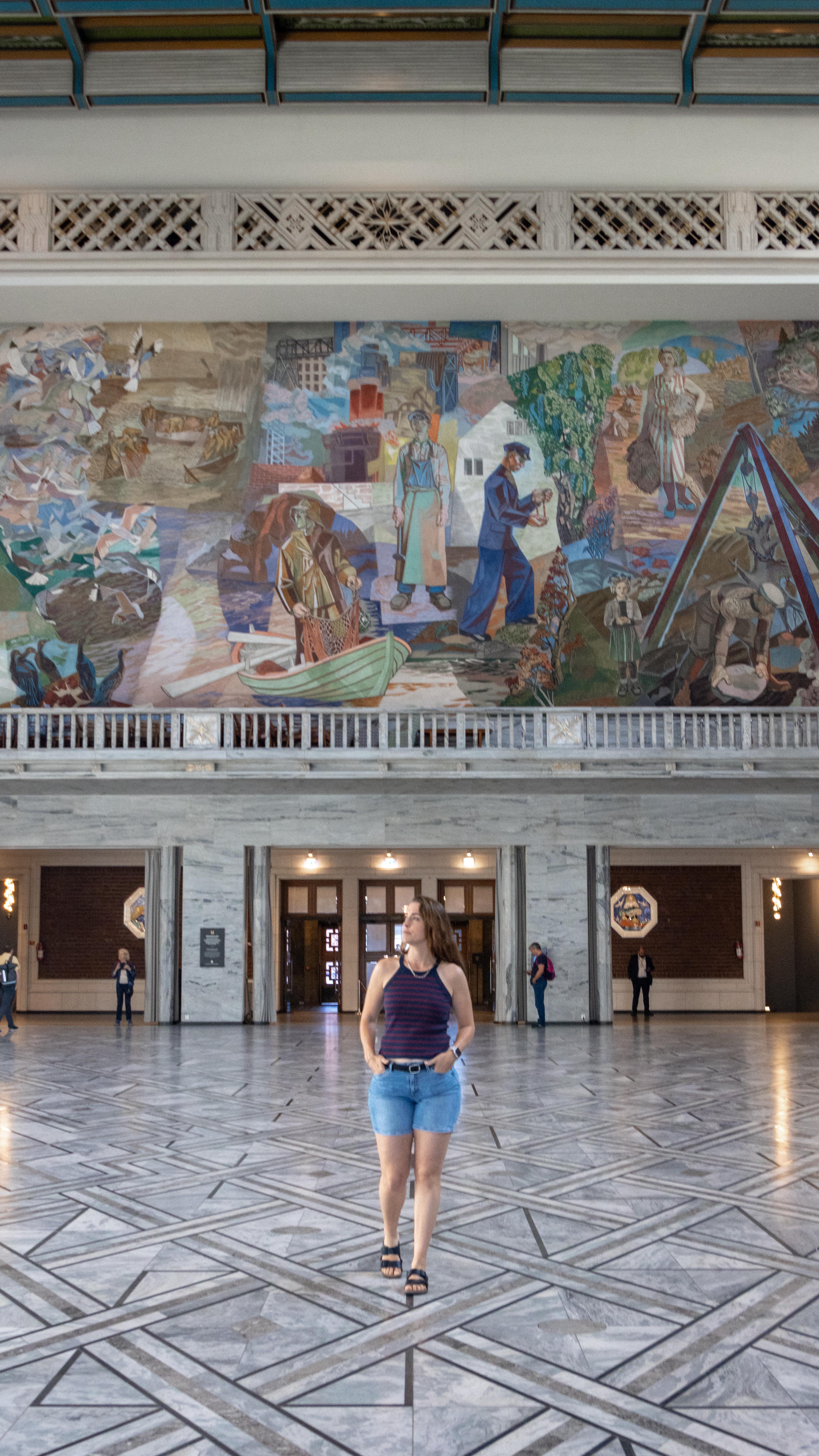 Instagram post by @nomadicspaniard for Girls LOVE Travel. Caption reads: Did you know you can enter the Oslo City Hall for....
