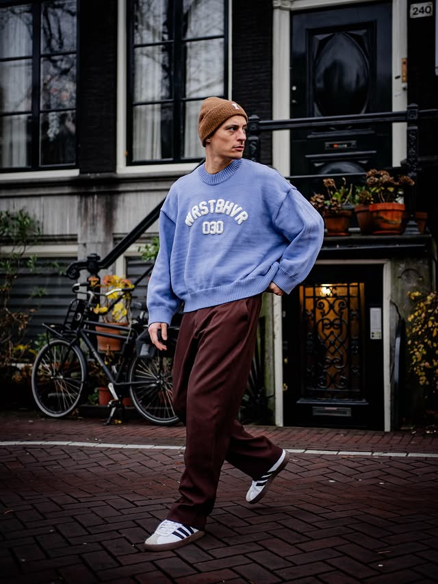 Instagram post by @der_mamo for AMI Paris. Caption reads: [...] Typisch Amsti oder? Beanie @amiparis Knit....