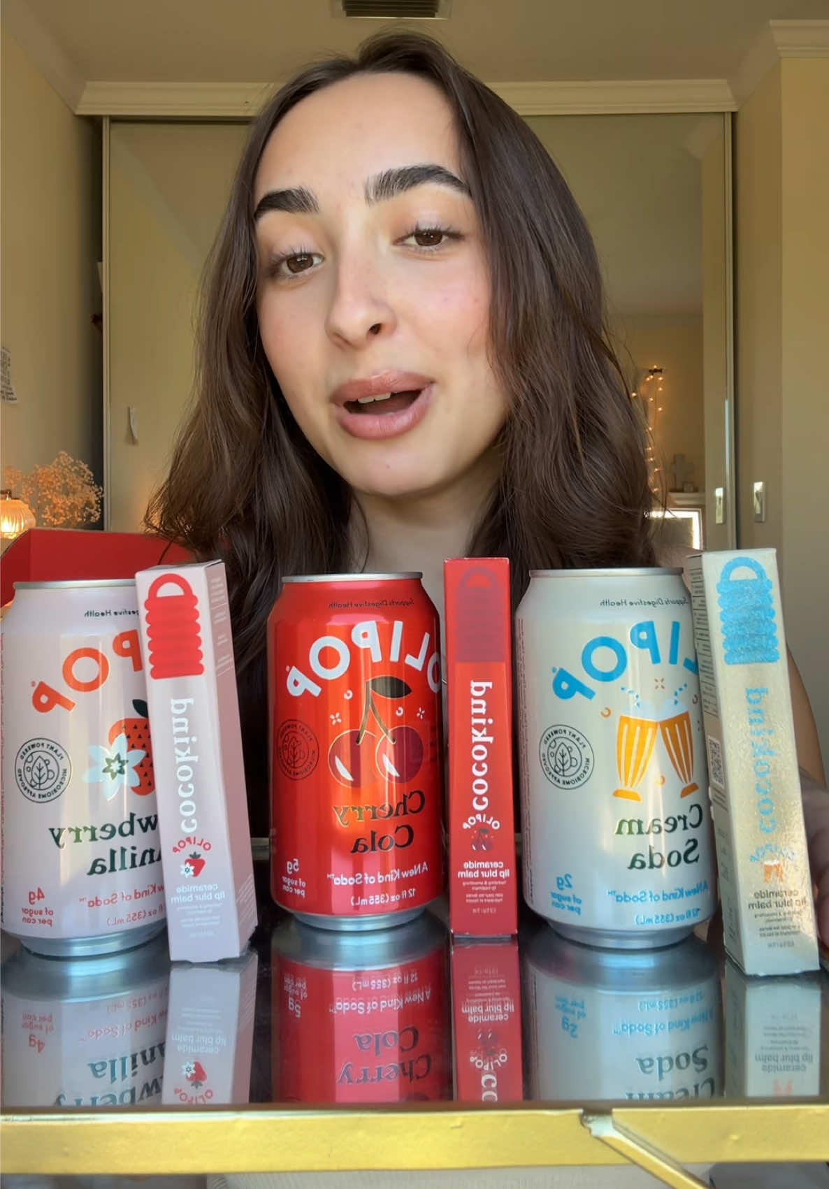 TikTok post by @noelle_asmr for Cocokind. Caption reads: [...] my fav in lippie and soda form #olipop....