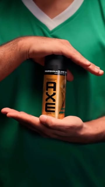 Instagram post by @dina_alhadoua for AXE. Caption reads: [...] At least we'll keep smelling good with AXE.....