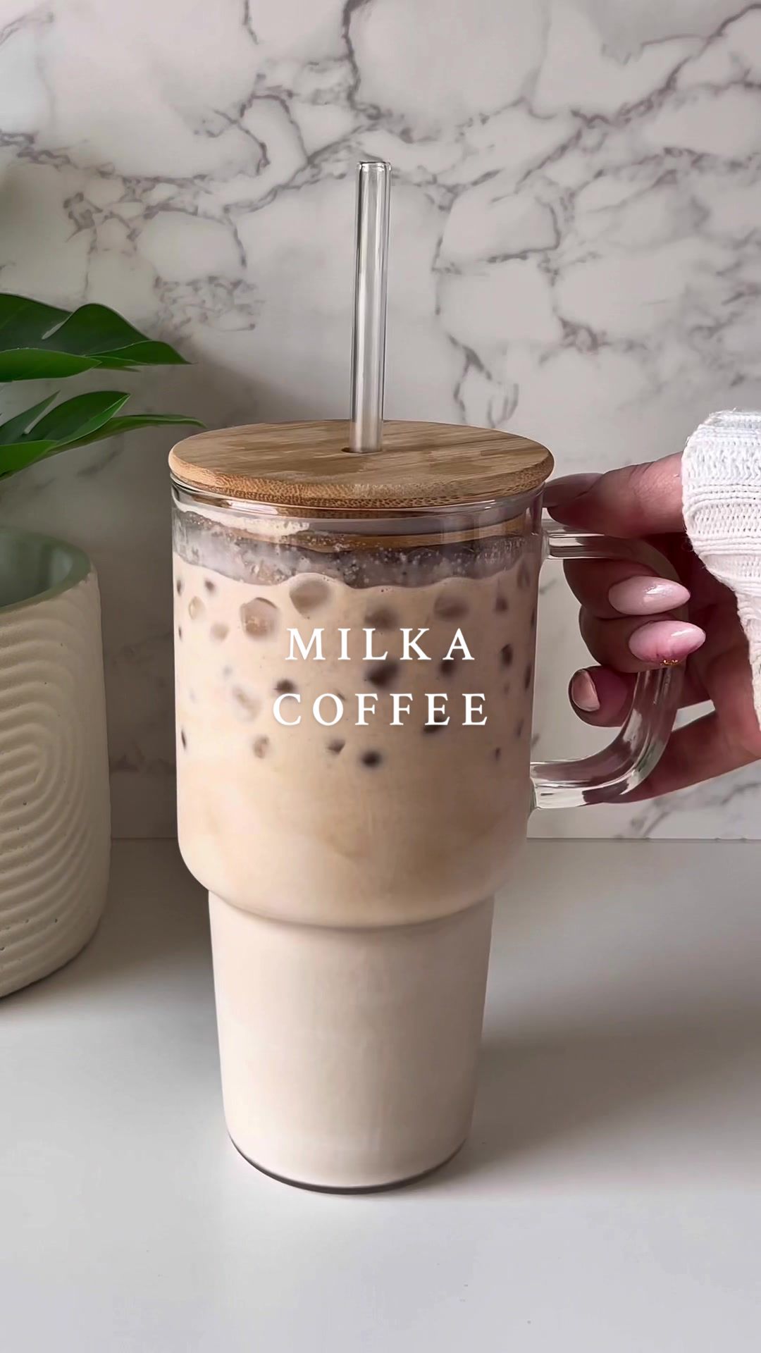 TikTok post by @michellebreax for Milka. Caption reads: Milka iced chocolate 🍫🤎☕️ Ingredients: - ice....