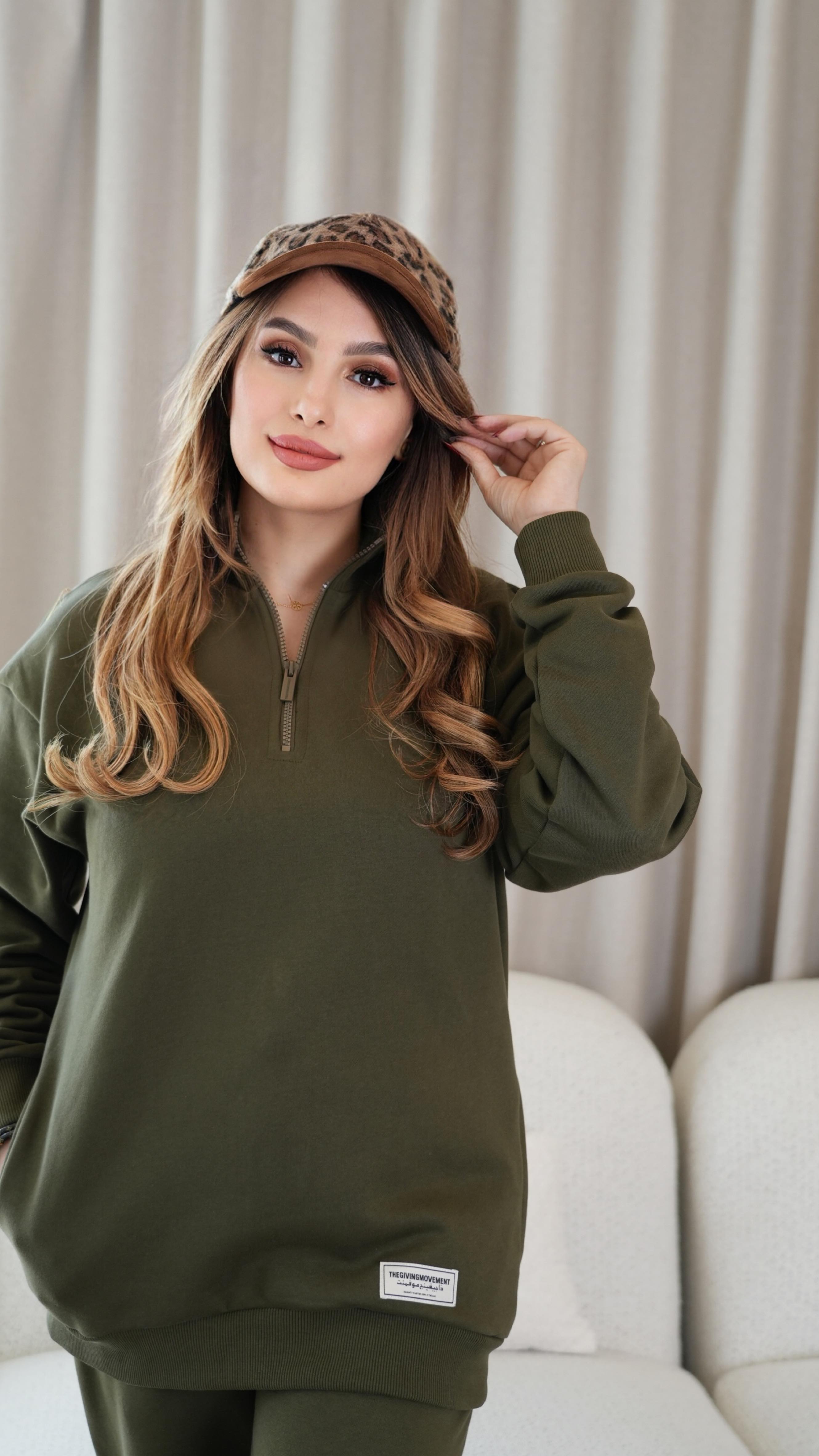 Instagram post by @sura_abiya7 for The Giving Movement. Caption reads: Autumn layers, cozy tones, and that new olive....