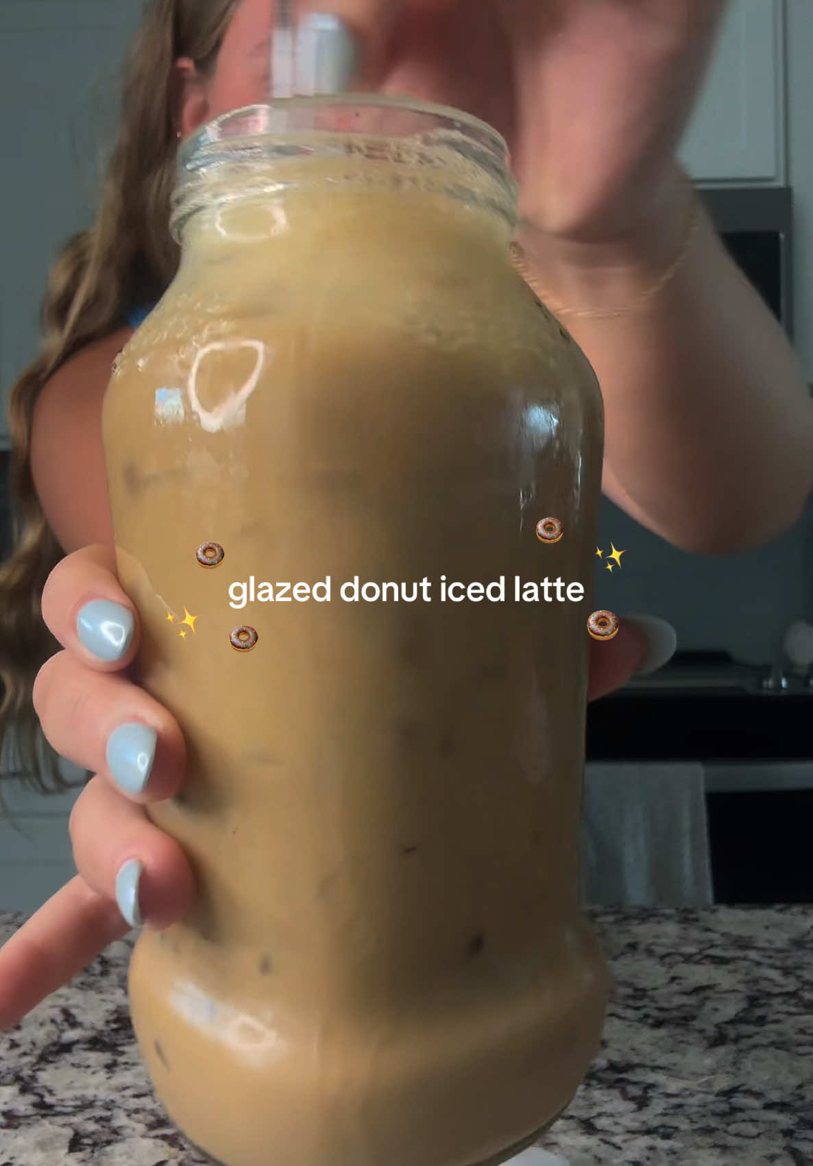 TikTok post by @kceastlanddd for Syruvia. Caption reads: Iced glazed donut latte, please!✨🍩 So so good!....